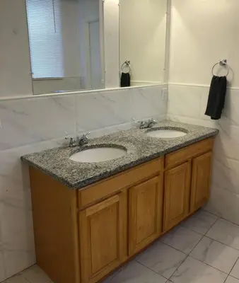 a bathroom with two sinks and a large mirror at Large apartment, sleeps up to 10 people comfortably, direct NYC Manhattan train only 5 minute walk away, MetLife Stadium FIFA World Cup 25 minutes away in Elizabeth
