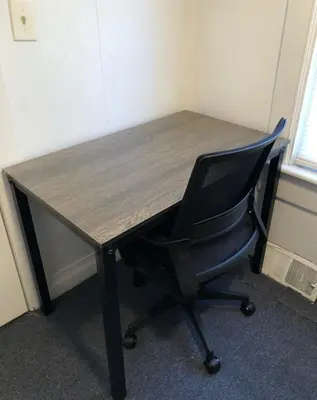 an office desk with a chair and a wooden top at Private and cozy house with one bedroom and one bathroom, MetLife Stadium FIFA World Cup 35 minutes away in Perth Amboy