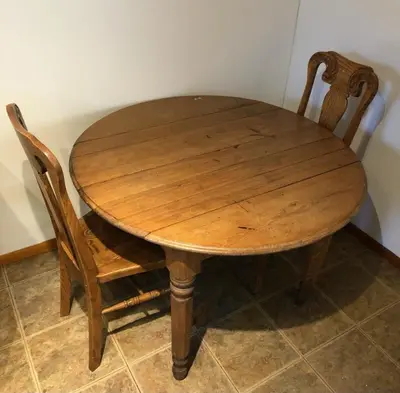 a wooden table with two wooden chairs around it at Private and cozy house with one bedroom and one bathroom, MetLife Stadium FIFA World Cup 35 minutes away in Perth Amboy