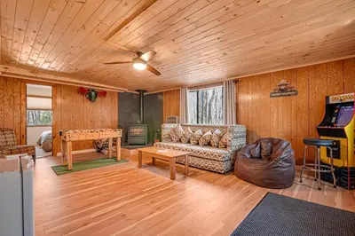a living room with a couch and a table at Ski, Unwind, Play Near Big Boulder, Game Room in Blakeslee