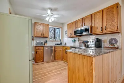 a kitchen with wooden cabinets and a ceiling fan at Ski, Unwind, Play Near Big Boulder, Game Room in Blakeslee