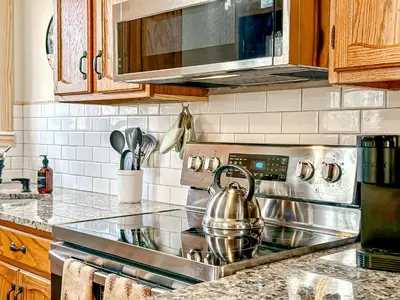 a kitchen with a stove with a tea kettle on it at Ski, Unwind, Play Near Big Boulder, Game Room in Blakeslee