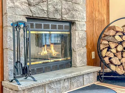 a fireplace in a house with a stone wall at Ski, Unwind, Play Near Big Boulder, Game Room in Blakeslee