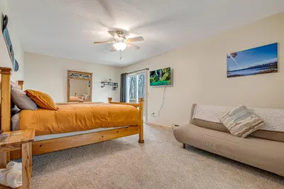 a bedroom with a bed and a couch at Ski, Unwind, Play Near Big Boulder, Game Room in Blakeslee