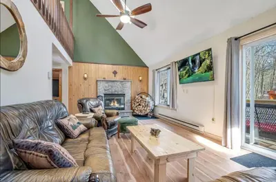 a living room with leather furniture and a fireplace at Ski, Unwind, Play Near Big Boulder, Game Room in Blakeslee