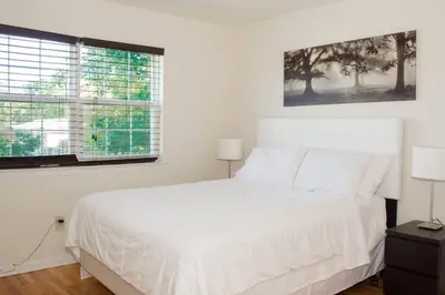 a white bedroom with a white bed and a window at Golf view family friendly 3 bed room Bridgewater apt close to Bridgewater Mall in Bridgewater