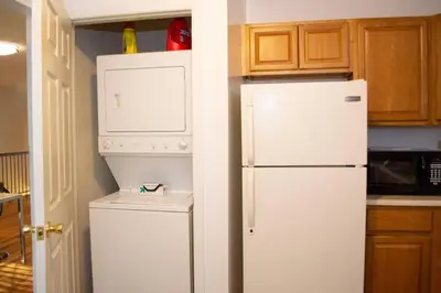 a kitchen with a white refrigerator and a washer at Golf view family friendly 3 bed room Bridgewater apt close to Bridgewater Mall in Bridgewater