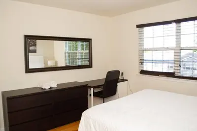 a bedroom with a bed and a desk and a mirror at Golf view family friendly 3 bed room Bridgewater apt close to Bridgewater Mall in Bridgewater
