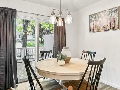 a dining room with a table and chairs and a window at Luxurorious Townhome In Reading in Mount Penn