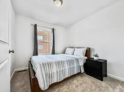 a white bedroom with a bed and a window at Luxurorious Townhome In Reading in Mount Penn