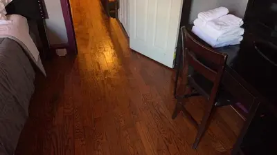 a room with a bed and a wooden floor at 2218 N Colorado Master Queen Room in Dogwood Acres