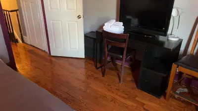 a room with a desk with a television and a chair at 2218 N Colorado Master Queen Room in Dogwood Acres