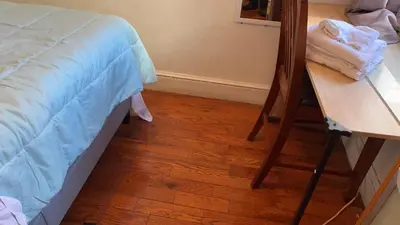 a bedroom with a bed and a wooden floor at 2218 N Colorado Double Rooms in Eldorado