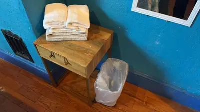 a small table with towels and a trash can at 2218 N Colorado Double Rooms in Eldorado