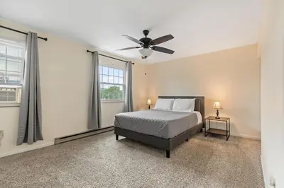 a bedroom with a bed and a ceiling fan at Comfy Stay Modern in Highspire