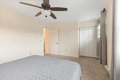 a bedroom with a bed and a ceiling fan at Comfy Stay Modern in Highspire