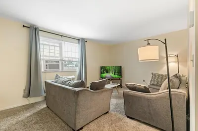 a living room with two couches and a tv at Comfy Stay Modern in Highspire