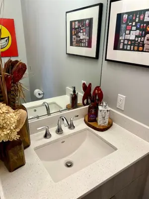 a bathroom with a white sink and a mirror at Charles Peak Condo - JC Heights in Jersey City