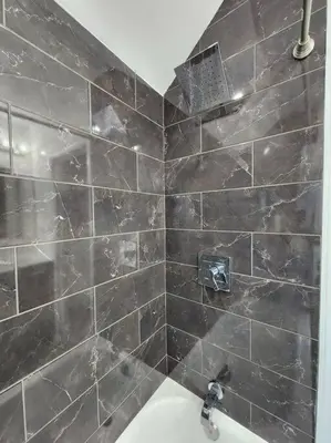a bathroom with a tiled shower with a sink at Two-Bedroom Home 25 min to NYC free parking-UNIT-2 in Teaneck
