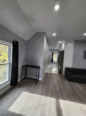 an empty living room with a table and a window at Two-Bedroom Home 25 min to NYC free parking-UNIT-2 in Teaneck