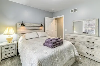 a bedroom with a bed and a dresser and a mirror at Mountain Views and Brook Access Home in Arkville! in Arkville