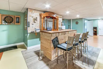a bar in a room with a bunch of chairs at Mountain Views and Brook Access Home in Arkville! in Arkville