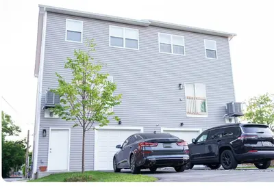 two cars parked in front of a house at Hidden Gem in Norristown