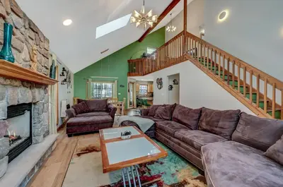 a living room with a couch and a fireplace at Locust Lake Livin Hot Tubfire Pitskiingpets in Pocono Lake