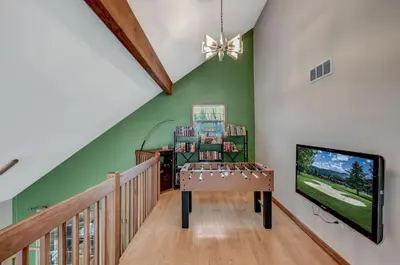 a living room with green walls and a tv at Locust Lake Livin Hot Tubfire Pitskiingpets in Pocono Lake