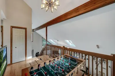 a home gym with a ping pong table in the middle at Locust Lake Livin Hot Tubfire Pitskiingpets in Pocono Lake