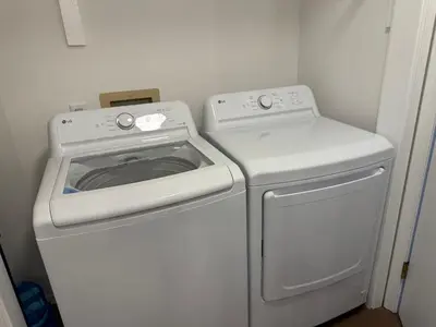 a white washer and dryer in a room at POCONOS everything close to Luxury vacational home in the heart of poconos with 3 outdoor pools for the public of the Tobyhanna community in Tobyhanna