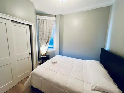 a bedroom with a white bed and a window at Spacious 3-bedroom Apartment Stunning Views NYC in Union City