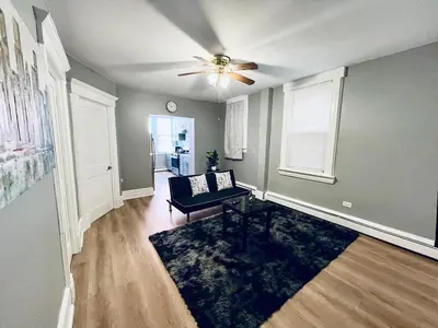 a living room with a couch and a ceiling fan at Spacious 3-bedroom Apartment Stunning Views NYC in Union City