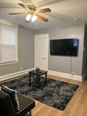 a living room with a ceiling fan and a table at Spacious 3-bedroom Apartment Stunning Views NYC in Union City