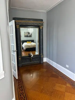 a room with a mirror and a bed in it at Spacious 3-bedroom Apartment Stunning Views NYC in Union City