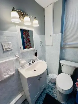 a bathroom with a white toilet and a sink at Spacious 3-bedroom Apartment Stunning Views NYC in Union City