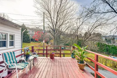 a wooden deck with chairs and potted plants on it at Bethlehem Home with Patio and Amazing Sunset Views! in Bethlehem