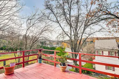 a red wooden deck with potted plants on it at Bethlehem Home with Patio and Amazing Sunset Views! in Bethlehem