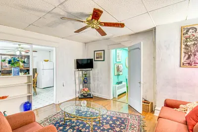 a living room with a ceiling fan and a glass table at Bethlehem Home with Patio and Amazing Sunset Views! in Bethlehem