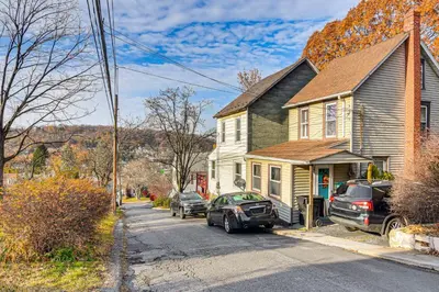 a house with two cars parked in front of it at Bethlehem Home with Patio and Amazing Sunset Views! in Bethlehem