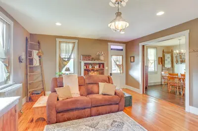 a living room with a couch and a dining room at 3 Mi to Dtwn Charming Farmhouse in Mount Joy! in Mount Joy
