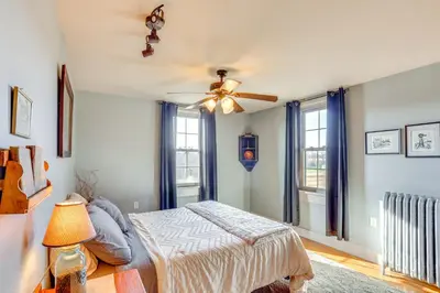 a bedroom with a bed and a ceiling fan at 3 Mi to Dtwn Charming Farmhouse in Mount Joy! in Mount Joy