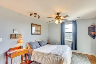 a bedroom with a bed and a ceiling fan at 3 Mi to Dtwn Charming Farmhouse in Mount Joy! in Mount Joy