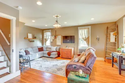 a living room with a couch and a table at 3 Mi to Dtwn Charming Farmhouse in Mount Joy! in Mount Joy