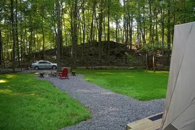 a car parked in a garden with a red chair at Lenape at Moon Valley Campground in Vernon Township