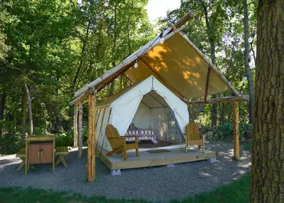 a tent with two chairs and a table at Hilltop Hideaway at Moon Valley Campground in Vernon Township