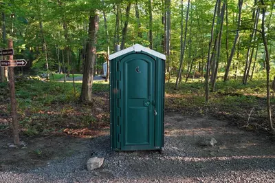 a green box sitting in the middle of a park at Hilltop Hideaway at Moon Valley Campground in Vernon Township