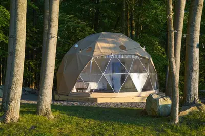a dome tent in the middle of a forest at The Lookout at Moon Valley Campground in Vernon Township