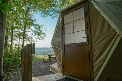 a door to a tent with a picnic table at The Lookout at Moon Valley Campground in Vernon Township