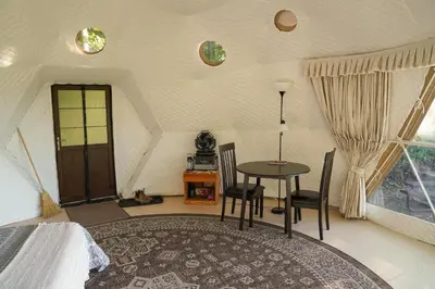 a bedroom with a table and chairs in a room at The Lookout at Moon Valley Campground in Vernon Township